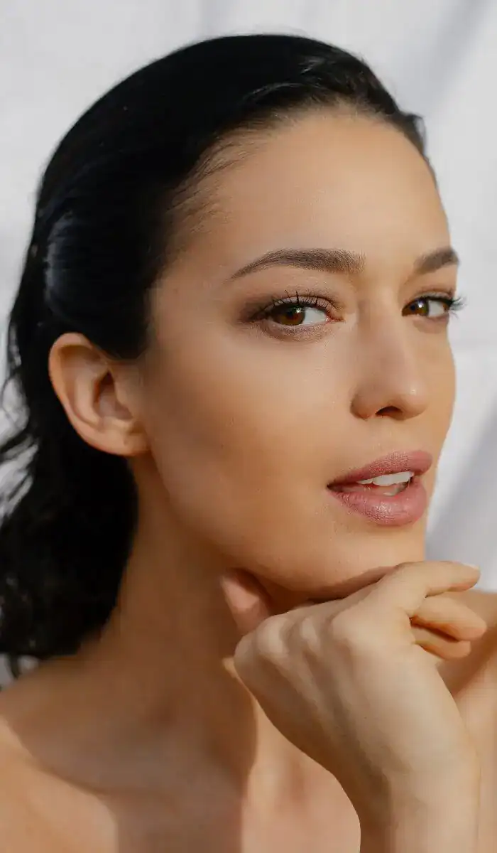 Close-up portrait of woman with smooth, radiant skin and natural makeup.