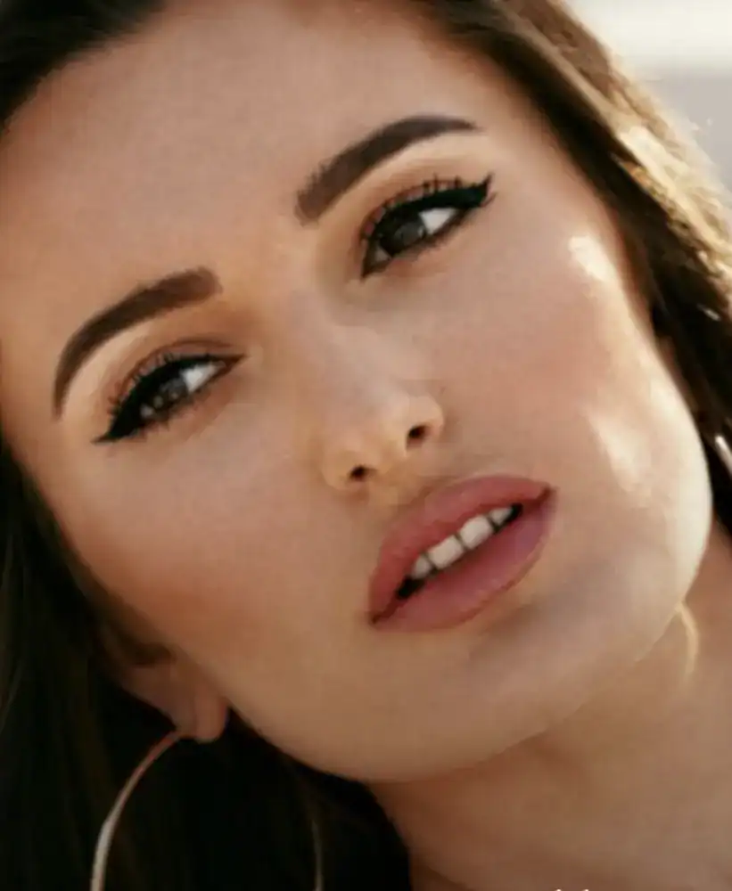 Close-up portrait of a woman with smooth skin, defined eyebrows, and natural makeup.