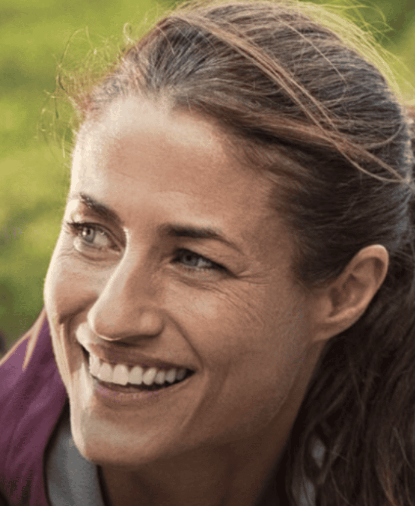 Happy woman smiling outdoors with natural light