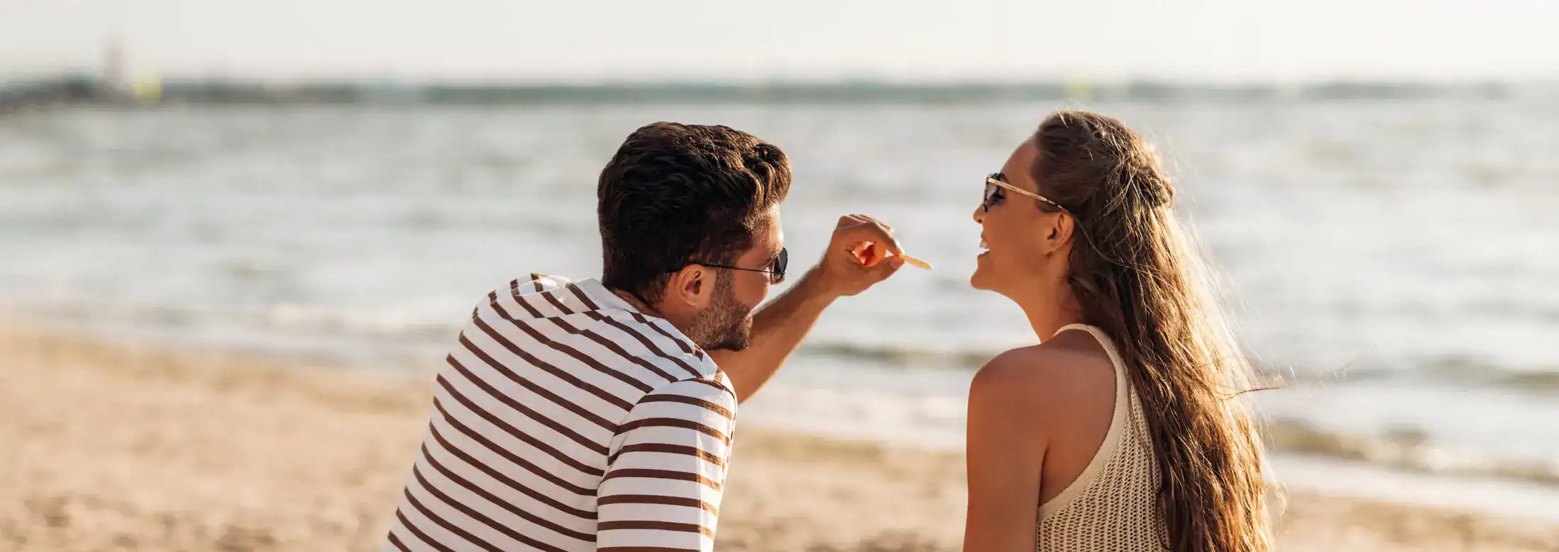 Couple enjoying beach picnic