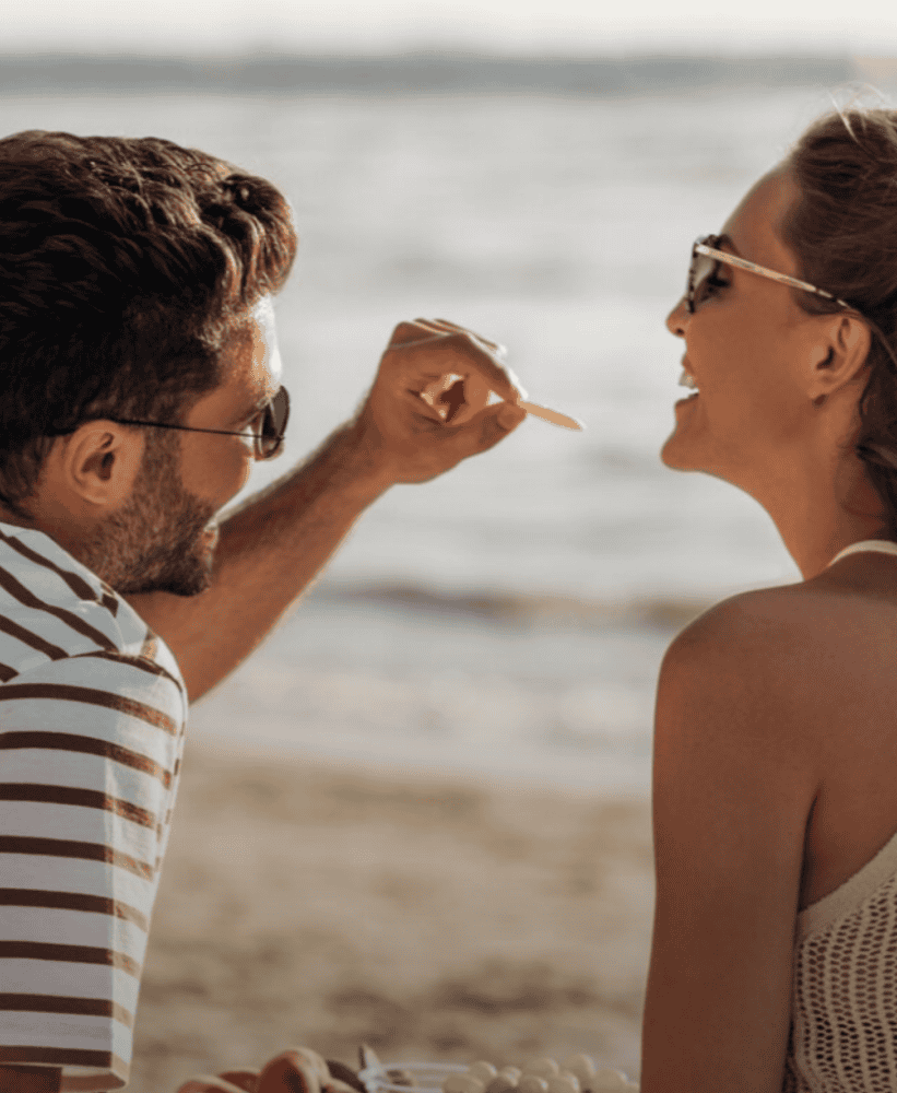 Couple enjoying beach picnic