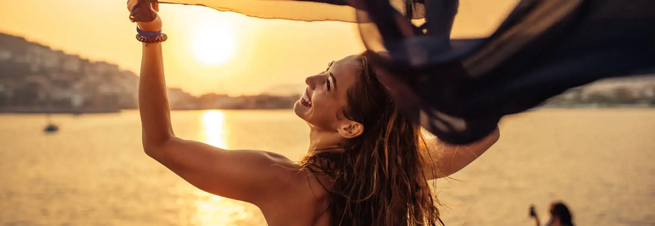 Woman enjoying sunset by water