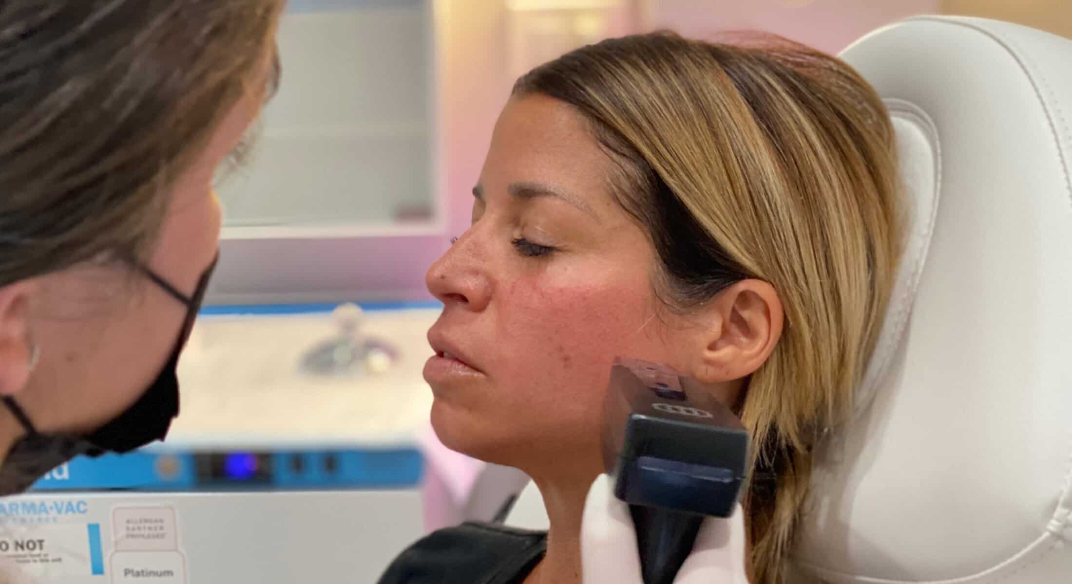 Provider performing a facial skin treatment on a client at Begin Anew Med Spa.