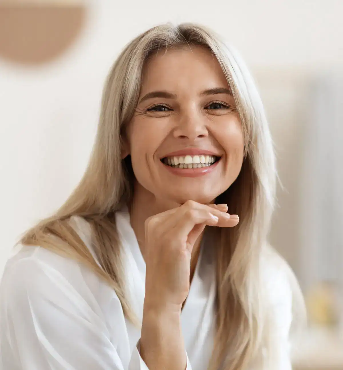 Smiling woman with healthy skin and blonde hair representing med spa wellness results.