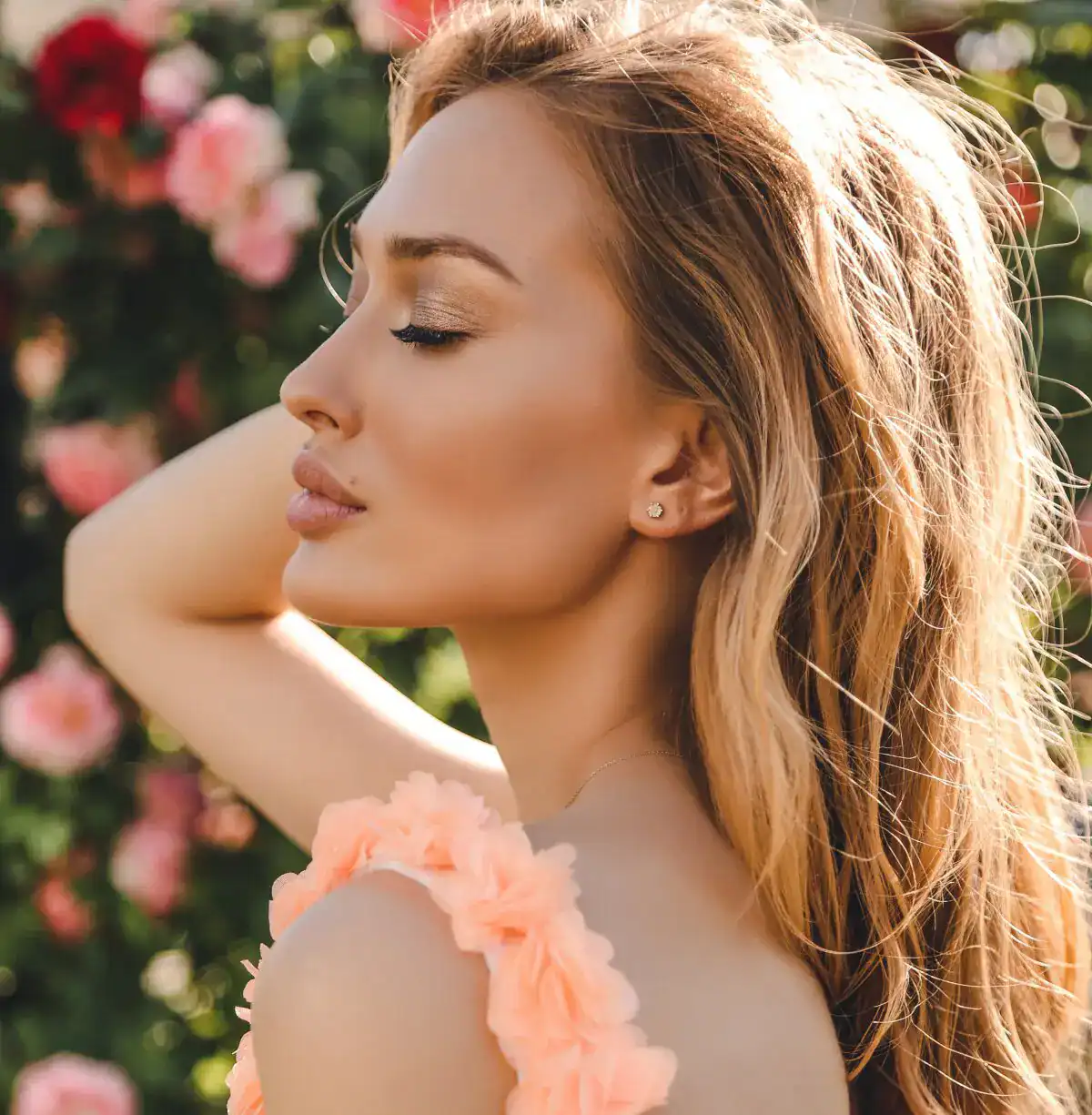 Beautiful woman in floral dress with glowing skin representing aesthetic rejuvenation.