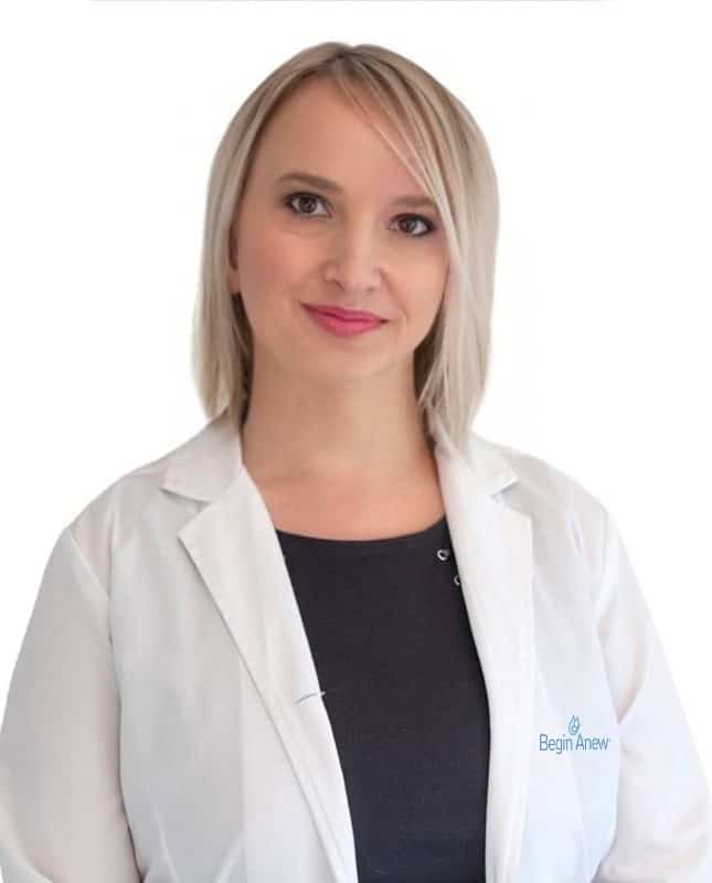 Person in lab coat, professional attire.