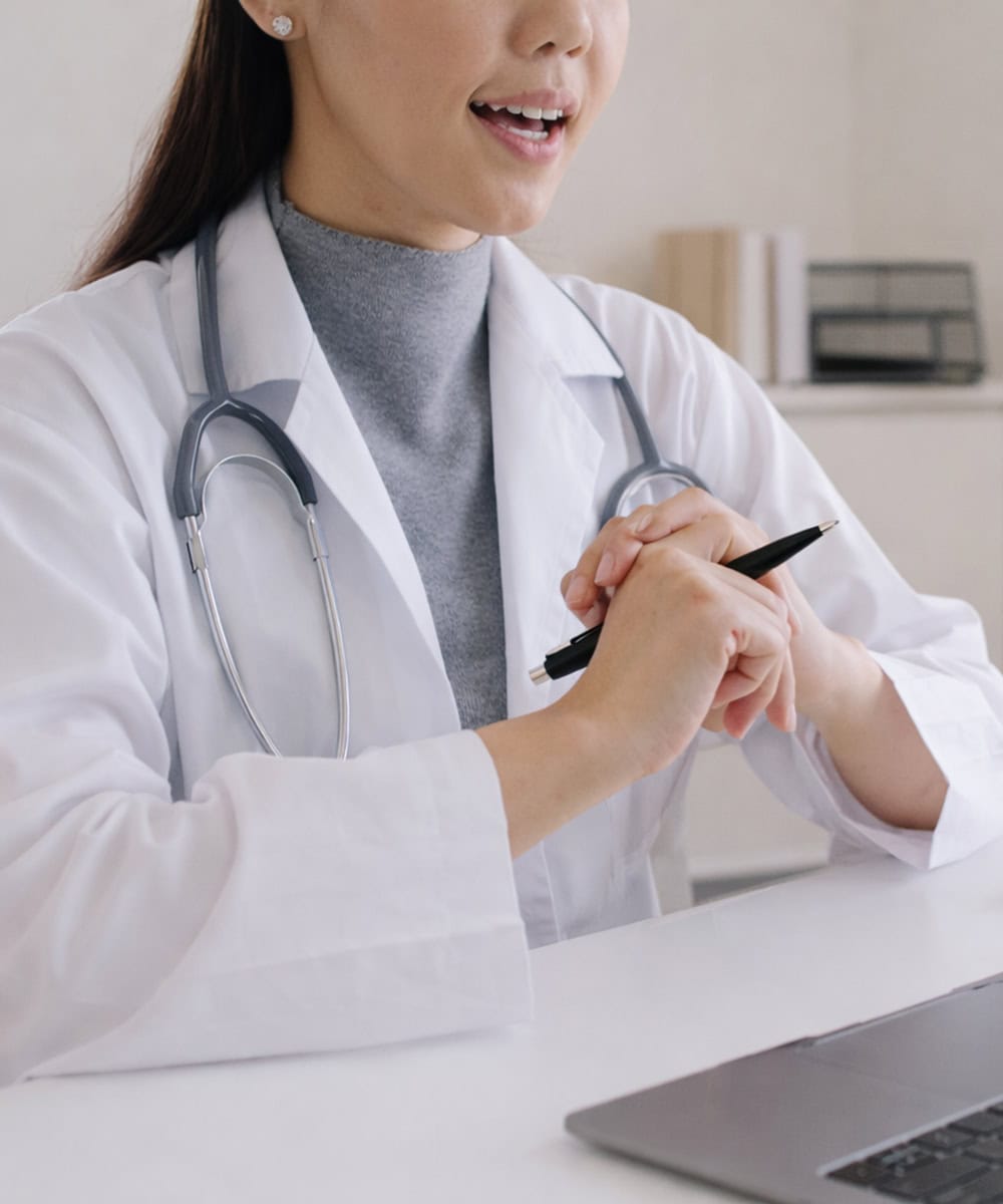 Person in medical attire at desk